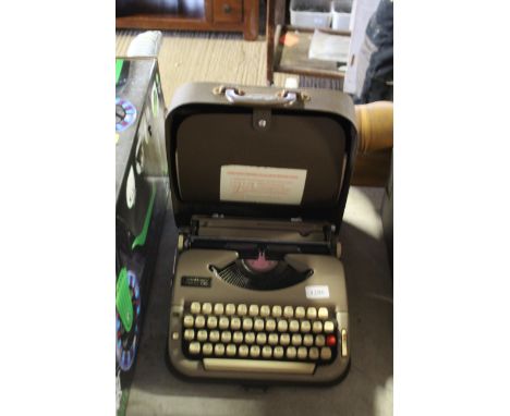 A Scheidigger portable typewriter in carry case
