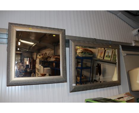 A framed and bevel edged hall mirror together with another