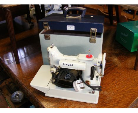 A vintage Singer sewing machine with original box, manual and accessories - Model 221