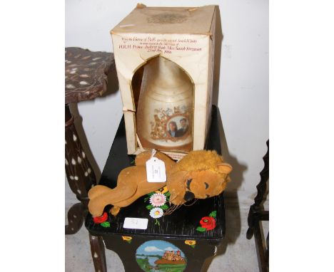A commemorative Bell's Scotch Whisky decanter, together with an old straw filled toy lion