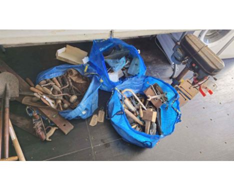 A pillar drill, together with other tools contained in three Ikea bags