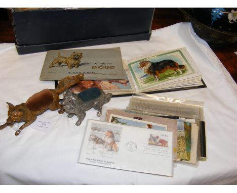 Two reproduction dog pin cushions, together with collectable postcards and cigarette cards relating to dogs