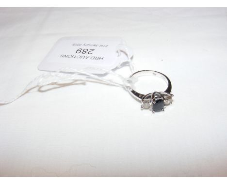 A diamond and sapphire three stone ring in 18ct white gold setting