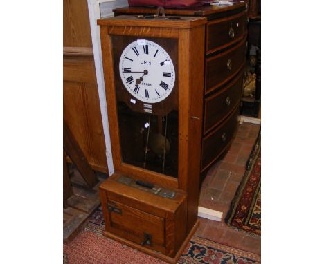 A 1930's British railway 'clocking in' clock for L.M.S with oak case, winding key and locks - 104cm high