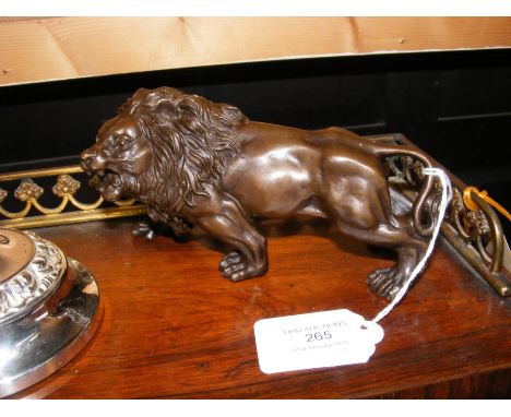 A reproduction bronze lion ornament - 14.5cms long
