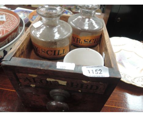 A vintage apothecary drawer and similar glass jars 