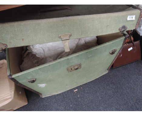 A vintage canvas trunk and contents