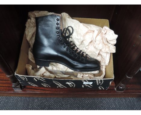 A pair of gents vintage unworn black leather ice skating boots by Fagan Pathfinder and CCM ice skating equipment,  size 10