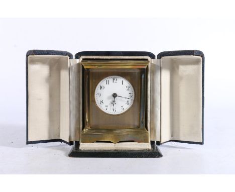 French brass carriage clock in serpentine case 9.5cm tall in fitted travel case. 