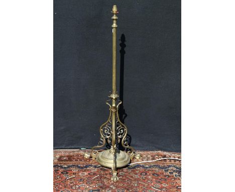 Art Nouveau brass telescopic standard lamp, raised on paw supports, the underside with reg. no. 410811, 124cm high. 