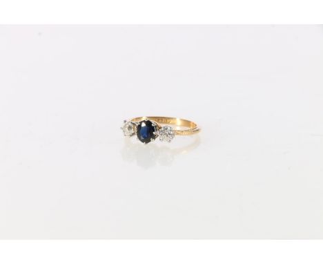 Gold, diamond and sapphire three stone lady's ring, the central sapphire flanked by two diamonds, marks to shank unclear, siz
