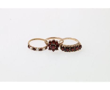 9ct yellow gold garnet set dressing ring, 3.5g, size p, a 9ct gold garnet set flowerhead ring, London, 2.6g, size M, and a 9c