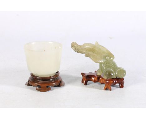 Jade style cup on hardwood stand, 7cm diameter and a jade style fish model on hardwood stand, 7cm tall. 