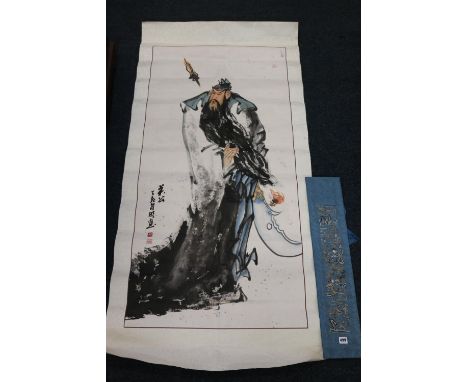 Chinese watercolour of an executioner on silk backing, an embroidered silk panel in blue, 70cm x 15cm and a Chinese scroll wa