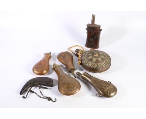 Four Victorian brass and copper powder flasks, an Indian brass mounted wooden powder flask and an antique moon flask, for pow