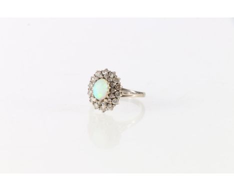 Antique white metal diamond and opal set lady's cluster ring, the central opal surrounded by twenty-eight diamonds, size Q, 5