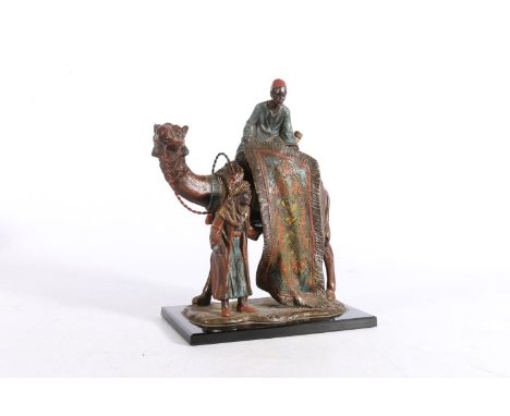 Austrian Bergman style cold painted spelter table lighter in the form of a camel and two Arabian rug sellers, 29cm tall. 