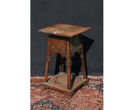 Art Nouveau carved oak worktable, in the manner of Liberty's, the base with four fall front cupboards, with copper mounts, ra