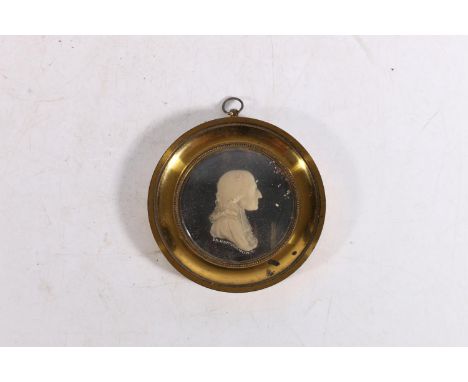 J G HANCOCK, a carved wax profile portrait miniature of Reverend John Wesley, held within a gilt metal frame with annotation 