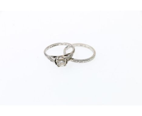 Platinum and diamond solitaire ring, size J, 3.4g, and a matching platinum engraved wedding band, size K, 2.6g. 