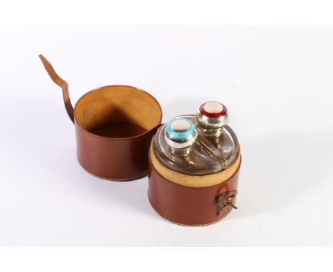 Victorian leather cased cylindrical twin bottle travelling set, with sterling silver and enamel tops in red and blue, Levi &a