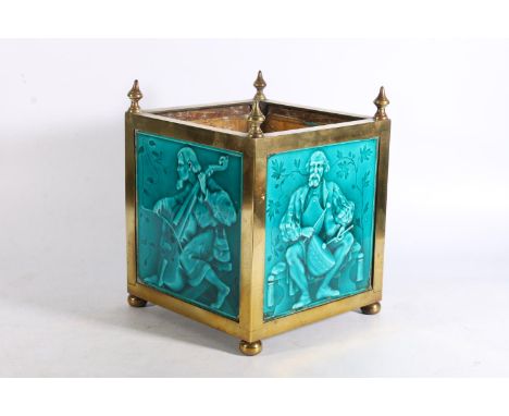 Art Nouveau period brass jardiniere inset with four blue glazed pottery tiles depicting musicians in the manner of Minton Hol