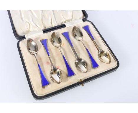 Cased set of six sterling silver teaspoons, with blue enamel terminals, Len & Salaman, Birmingham, 1922, 71g.  Enamel damaged