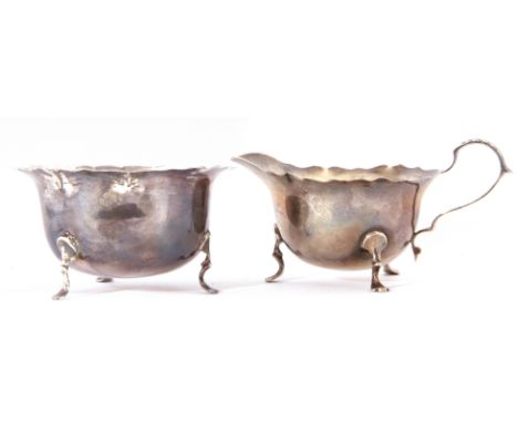 Edward VII sugar basin and milk jug, each with cut card rims and raised on applied feet, combined weight approx 94gms, London