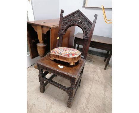 Late 19th century oak hall chair with carved back, seat and legs and an inlaid tapestry topped footstool
