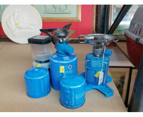 Two butane gas camping stoves, 2 spare gas cylinders, and a camping light 