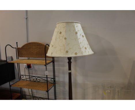 A mahogany lamp standard with shade 
