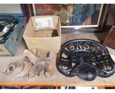 Box of rams horns and a cast iron tractor seat, black stone Stamford