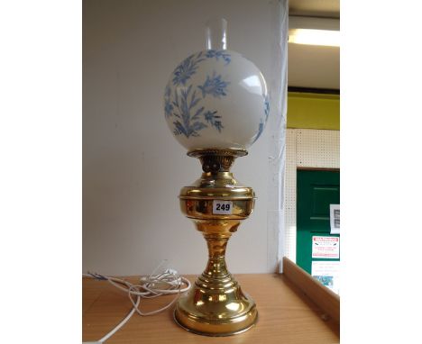 Edwardian plain brass oil lamp with opaque spherical glass shade and clear chimney        