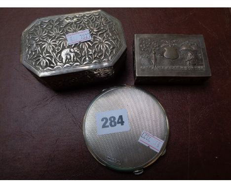 Asian Silver Elephant decorated lidded pot, figural decorated white metal box and a Silver machined compact     