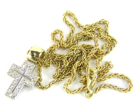 An 18ct gold and diamond set crucifix pendant and chain, with small crucifix pendant set with tiny diamonds and a pierced cen