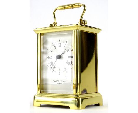 A Till &amp; Bligh London brass cased carriage clock, with swing handle in rectangular single glazed panel case, on bracket f