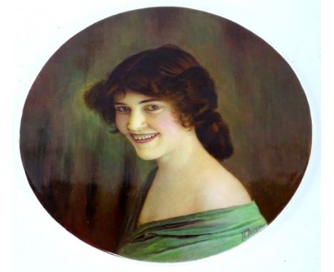 A 1930s porcelain plaque, painted with a portrait of a young lady, by James Edwin Dean, 25cm diameter.