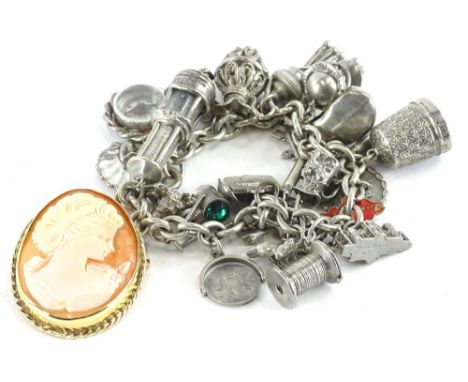 A silver charm bracelet containing various white metal and white coloured metal charms, to include a golf club, compass, mine