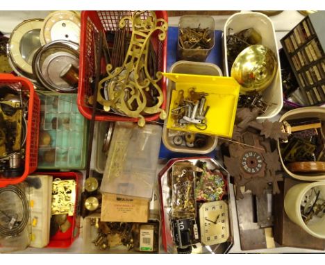 A large quantity of clock parts, to include some part movements, dials, bezels, a cuckoo clock case with movement and some pa