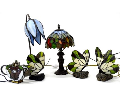 A collection of Tiffany style light fittings, to include a small lamp base with stained glass shade, 36cm high, another lamp 