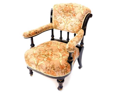 A late Victorian ebonised and parcel gilt open armchair, with a padded button back, arm rests and seat, on turned supports wi