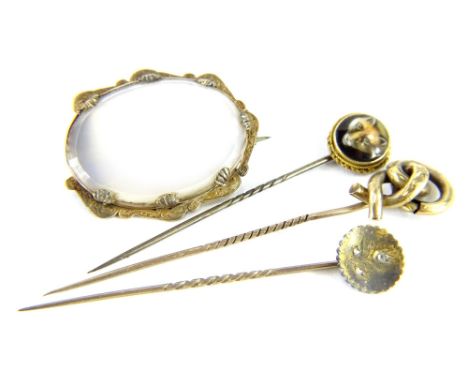 Three stick pins and a brooch, to include a gold framed and enamel fox head pin, a knot design pin, and a gold and seed pearl