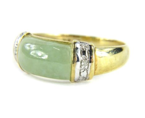 A jade and diamond dress ring, with baguette cut jade, and tiny diamond set sides in a white gold setting, on a yellow metal 