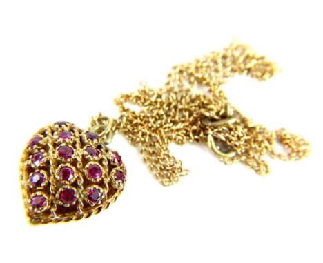 A 9ct gold garnet set heart pendant and chain, the heart pendant of pierced twist and openwork design, on a plain back, on fi