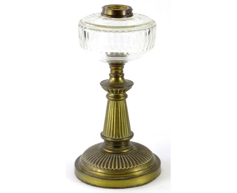 A Victorian reeded brass oil lamp base, with clear faceted glass reservoir, 35cm high.