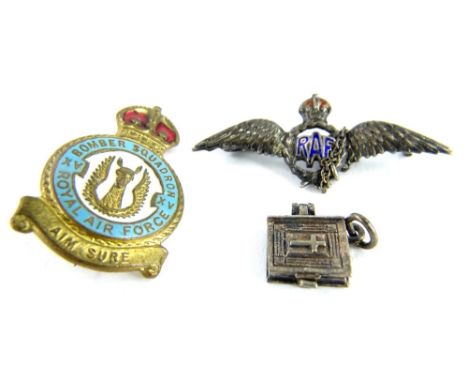 RAF related jewellery, comprising a silver and enamel RAF wings brooch, a Bomber Squadron pin and a silver plated book charm.