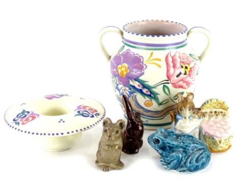 A Poole pottery two handled vase, decorated in typical flower, leaves, etc., impressed factory mark to underside on a coral g
