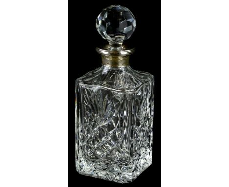 A 20thC cut glass decanter of shouldered form, with a repeat geometric hobnail cut, floral pattern and orb stopper with silve