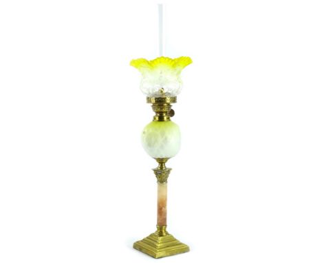 A Victorian brass oil lamp, with a small yellow and white frosted shade, brass fitting, the yellow and white opaque satin gla