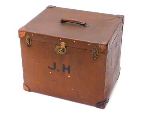 An Edwardian canvas trunk or storage box, with leather corners, the lid enclosing a fitted interior and label for Henry A Mer